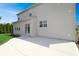 Exterior of the home featuring a large patio with a sliding glass door and green lawn at 5702 Saratoga Pl, Plainfield, IN 46168