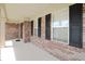 Cozy covered porch with brick columns, offering a shaded spot to relax and enjoy the neighborhood view at 5702 Saratoga Pl, Plainfield, IN 46168