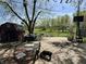 The backyard features a shed, trees, and a patio, with a dog in the foreground at 5817 Oliver Ave, Indianapolis, IN 46241