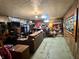 A basement with wood paneling and a window. It is filled with items and furniture at 5817 Oliver Ave, Indianapolis, IN 46241