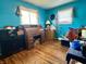 Bright bedroom with a wooden desk, hardwood floors, and two windows providing ample natural light at 5817 Oliver Ave, Indianapolis, IN 46241