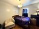Simple bedroom featuring hardwood floors, a wooden bed frame, and soft natural light creating a relaxing space at 5817 Oliver Ave, Indianapolis, IN 46241