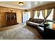 Inviting living room with wood paneling, a patterned rug, and comfortable seating near bright windows at 5817 Oliver Ave, Indianapolis, IN 46241