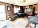Comfortable living space with patterned wallpaper, a floral armchair, and a view to the front yard at 5817 Oliver Ave, Indianapolis, IN 46241