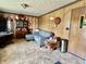 Cozy living room with paneled walls, traditional furniture, and vintage decor creating a warm atmosphere at 5817 Oliver Ave, Indianapolis, IN 46241