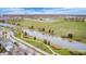 An aerial view showcasing lush green spaces, a serene pond, and modern community amenities at 5954 Crowley Pkwy, Whitestown, IN 46075