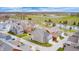Aerial view of a well-planned community featuring colorful homes, a pond, and plenty of green space at 5954 Crowley Pkwy, Whitestown, IN 46075
