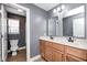 Bathroom features a double sink vanity with wood cabinets and a separate toilet area at 5954 Crowley Pkwy, Whitestown, IN 46075