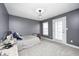This gray bedroom is complete with a bed, toys, and a door to access outside at 5954 Crowley Pkwy, Whitestown, IN 46075