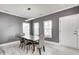 Cozy dining room featuring modern light fixture, wood table, and gray walls with white trim at 5954 Crowley Pkwy, Whitestown, IN 46075
