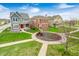 Aerial view of charming two-story house with manicured front yard, red door, and brick accents at 5954 Crowley Pkwy, Whitestown, IN 46075