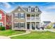 Charming two-story home featuring a covered front porch, black shutters, and well-maintained lawn at 5954 Crowley Pkwy, Whitestown, IN 46075
