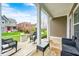 Cozy front porch with black rocking chairs overlooking a well-manicured lawn and street at 5954 Crowley Pkwy, Whitestown, IN 46075