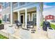 Charming front porch with rocking chairs, white planters, and a welcoming black door at 5954 Crowley Pkwy, Whitestown, IN 46075