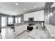 Modern kitchen with white cabinets, granite countertops, stainless steel appliances, and a view of the dining area at 5954 Crowley Pkwy, Whitestown, IN 46075