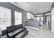 Open floor plan with modern furnishings, light wood floors and view to the kitchen area at 5954 Crowley Pkwy, Whitestown, IN 46075