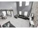 Spacious living room with two-story ceiling, fireplace, brick accent wall and plenty of natural light at 5954 Crowley Pkwy, Whitestown, IN 46075