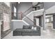 Elegant staircase with dark wood railing in a modern, gray-toned living space, flooded with light at 5954 Crowley Pkwy, Whitestown, IN 46075
