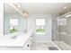Bright bathroom with dual sinks, large mirror, tiled shower, and ample natural light at 6040 Juniper Ct, Whitestown, IN 46075