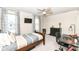 This is a nice bedroom with a ceiling fan, desk, and a mounted television at 6040 Juniper Ct, Whitestown, IN 46075