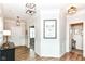 Welcoming foyer showcasing wood flooring, crown molding, and an eye-catching art print at 6040 Juniper Ct, Whitestown, IN 46075