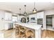 Bright kitchen featuring a large island with barstool seating, stainless steel appliances, and white cabinetry at 6040 Juniper Ct, Whitestown, IN 46075