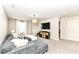 Inviting living room with a gray sectional sofa, media console, and natural light at 6040 Juniper Ct, Whitestown, IN 46075