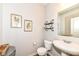 Cozy powder room boasts a pedestal sink, framed art, and a stylish industrial-style shelf at 6040 Juniper Ct, Whitestown, IN 46075
