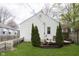 Exterior of home showcasing a backyard with green lawn, small deck, privacy fence and tidy landscaping at 6180 Crittenden Ave, Indianapolis, IN 46220