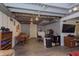Finished basement space with wood-look floors, dining area, and entertainment center; features painted ceilings and gray walls at 6180 Crittenden Ave, Indianapolis, IN 46220