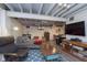 Finished basement with lounge area, TV, and wood-look flooring at 6180 Crittenden Ave, Indianapolis, IN 46220