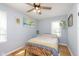 Bright bedroom with hardwood floors, ceiling fan, and natural light from large windows at 6180 Crittenden Ave, Indianapolis, IN 46220