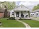 Charming single-story home featuring a cozy front porch and well-manicured lawn at 6180 Crittenden Ave, Indianapolis, IN 46220