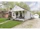 Charming single-story home with front porch, well-maintained lawn, and stone driveway at 6180 Crittenden Ave, Indianapolis, IN 46220