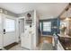 Functional kitchen area with white cabinets, stainless steel appliances, and modern flooring at 6180 Crittenden Ave, Indianapolis, IN 46220