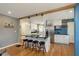 Modern kitchen featuring a spacious island with seating, stainless steel appliances, and white cabinetry at 6180 Crittenden Ave, Indianapolis, IN 46220