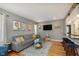 Bright living room with hardwood floors, a comfortable sectional sofa, and an open layout at 6180 Crittenden Ave, Indianapolis, IN 46220