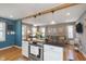 Open-concept living space with kitchen island, stainless steel appliances, and cozy living room area at 6180 Crittenden Ave, Indianapolis, IN 46220