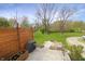 Landscaped backyard with patio, fire pit, garden, chair and barbecue at 6315 Shelbyville Rd, Indianapolis, IN 46237