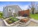 Charming backyard with wooden privacy fence, patio with barbecue, and mature landscaping at 6315 Shelbyville Rd, Indianapolis, IN 46237