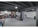 Spacious unfinished basement with painted floor and dark ceiling beams, offering potential for customization at 6315 Shelbyville Rd, Indianapolis, IN 46237