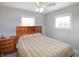 Comfortable bedroom with wood furniture, a cozy bed, and natural light from the window at 6315 Shelbyville Rd, Indianapolis, IN 46237
