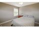 Comfortable bedroom featuring a bed with a patterned quilt and a neutral color scheme at 6315 Shelbyville Rd, Indianapolis, IN 46237
