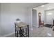 Cozy dining area featuring a small table and stools, with neutral walls, and view of the front door at 6315 Shelbyville Rd, Indianapolis, IN 46237
