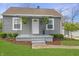 Charming single-story home featuring gray siding, a covered porch, and well-maintained landscaping at 6315 Shelbyville Rd, Indianapolis, IN 46237