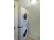 Compact laundry area featuring a stacked washer and dryer set for efficient space-saving at 6315 Shelbyville Rd, Indianapolis, IN 46237