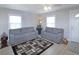 Inviting living room with neutral walls, two gray sofas, and a decorative rug, perfect for entertaining at 6315 Shelbyville Rd, Indianapolis, IN 46237