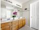 Bathroom with double sinks and vanity with a large mirror at 6527 Briarwood Pl, Zionsville, IN 46077