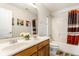 Neutral bathroom featuring a double vanity, shower, and decorative accents at 6527 Briarwood Pl, Zionsville, IN 46077