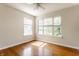 Bedroom with hardwood floors and a large window offering natural light at 6527 Briarwood Pl, Zionsville, IN 46077